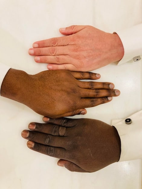 A close-up view of a diverse group of hands clasped together in a gesture of solidarity and support. The background is blurred, focusing attention on the hands as a symbol of unity against discrimination.
