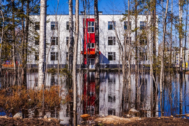 A split image showing a well-funded school with modern facilities on one side and a dilapidated, under-resourced school on the other, symbolizing the educational disparities resulting from redlining.