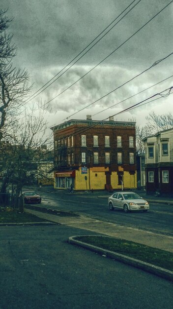 An old, run-down school building in a low-income neighborhood contrasted with a modern, well-equipped school building in a wealthy neighborhood. The contrast in infrastructure and resources is stark.
