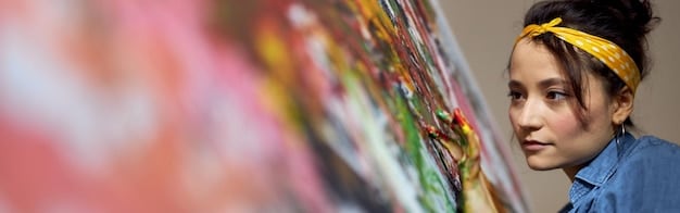 A student presenting a mixed media artwork during a class critique, showcasing a blend of traditional and digital techniques.